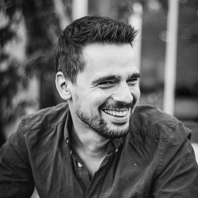 Tom Benattar, black and white portrait, laughing